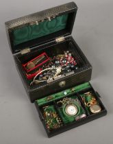 A leather jewellery box with fitted interior and contents. Includes silver fob watch, vintage