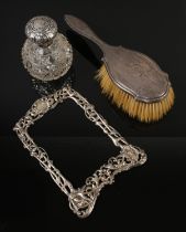 A collection of silver including hair brush, picture frame and cut glass scent bottle. Frame assayed