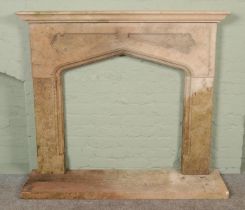 A reconstituted stone fireplace surround