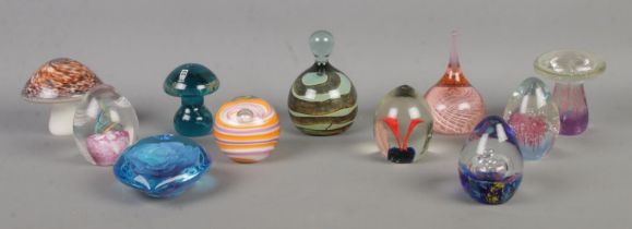 Eleven glass paperweights, to include Mdina, Wedgwood mushroom and swirl examples.