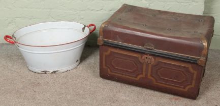 A twin handled tin trunk along with an enamel tub.