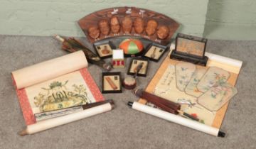 A box of Oriental collectables. Includes wooden mask display, scrolls, cork carving, parasols etc.