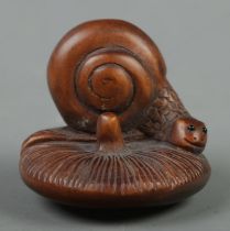 A Japanese carved Netsuke in the form of a snail on mushroom