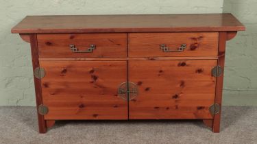 A Chinese style pine side cabinet. Hx72cm Wx140cm Dx40cm