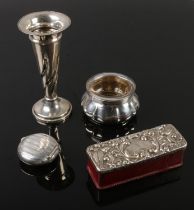 A collection of silver including pill box, candle stick, salt with glass interior and wooden box