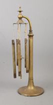 An early Twentieth Century set of brass table chimes, on circular base and swan neck. Height: 43cm.