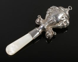 A vintage silver & mother of pearl rattle, hallmarked Birmingham 1934, 20.5g.