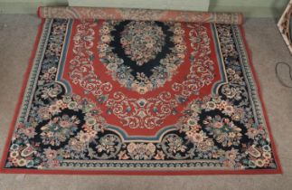 A large floor rug with red floral design. 340cmx240cm
