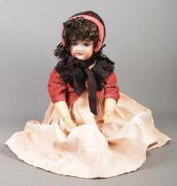 A Schoenau & Hoffmeister bisque head doll, with marks to the back of the neck; 1909, 5Â½, Germany.