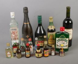 A collection of assorted alcohol, both full size and miniature, to include Creme De Menthe, Seigneur