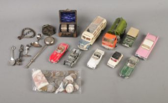 An assortment of collectables to include Dinky Diecast, silver plate, compass, international