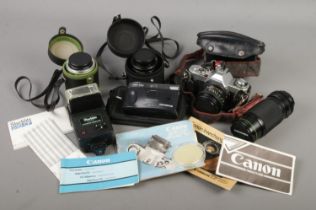 A camera bag with contents of Canon AV-1 camera, Olympus Trip 100, lenses, flash unit etc.