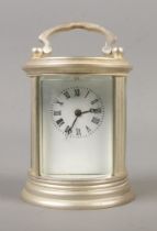 A miniature cylindrical carriage clock with 5 day movement and key. Height without handle 7cm.