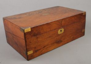 A Victorian mahogany writing slope with brass mounts and leather inset interior.