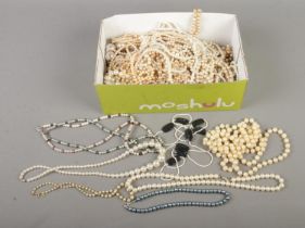 A box of simulated pearls to include multi-strand and Lotus examples.