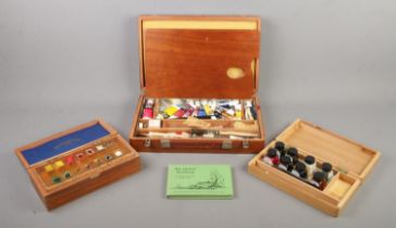 Three Winsor & Newton artist boxes with contents along with a singed copy of Ashley Jackson The