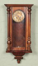 A carved mahogany wall clock with turned columns. In need of restoration