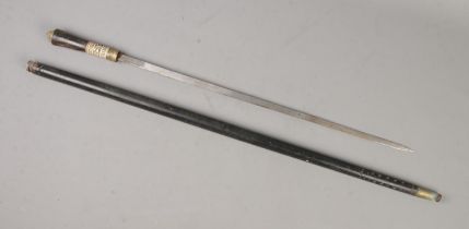A late 19th/early 20th century ebony sword stick featuring carved bone decoration and lion head on