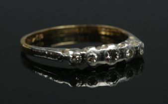 An 18ct gold five stone diamond ring. Size N. 1.97g. Slightly misshapen.
