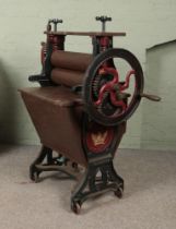 A painted cast iron mangle; 'The Dolly Washer', Taywil. With patent number 29445R and stamped '