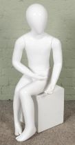 A shop mannequin formed as a seated child. (Hx100cm)