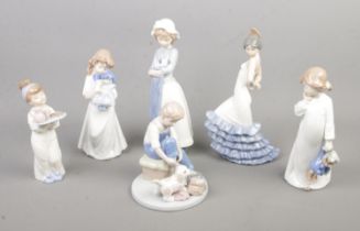 A collection of six Nao by Lladro figurines including Girl Holding Puppy With Blanket and Flamenco