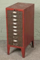 A red metal filing cabinet.
