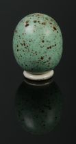 A miniature porcelain pepper pot modelled as a blackbird egg. Having screw base. Height 3.5cm.