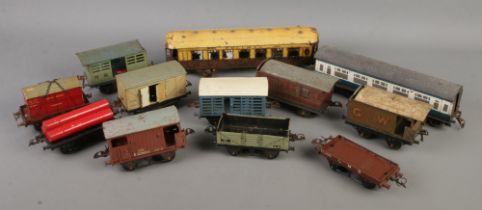 A good quantity of Hornby Meccano O gauge tin plate model railway wagons and carriages.