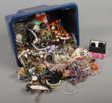 A box of costume jewellery. Includes brooches, beads, earrings, rings, watches etc.
