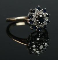 A 9ct gold diamond and sapphire halo cluster ring. Size I. 2.31g.