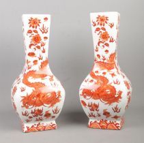 A large pair of oriental vases, decorated in dragons and flowers. Bearing four character marks to