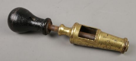An antique wine corker in brass and cast iron