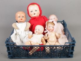 Four small Armand Marseilles bisque headed dolls, together with another similar example.