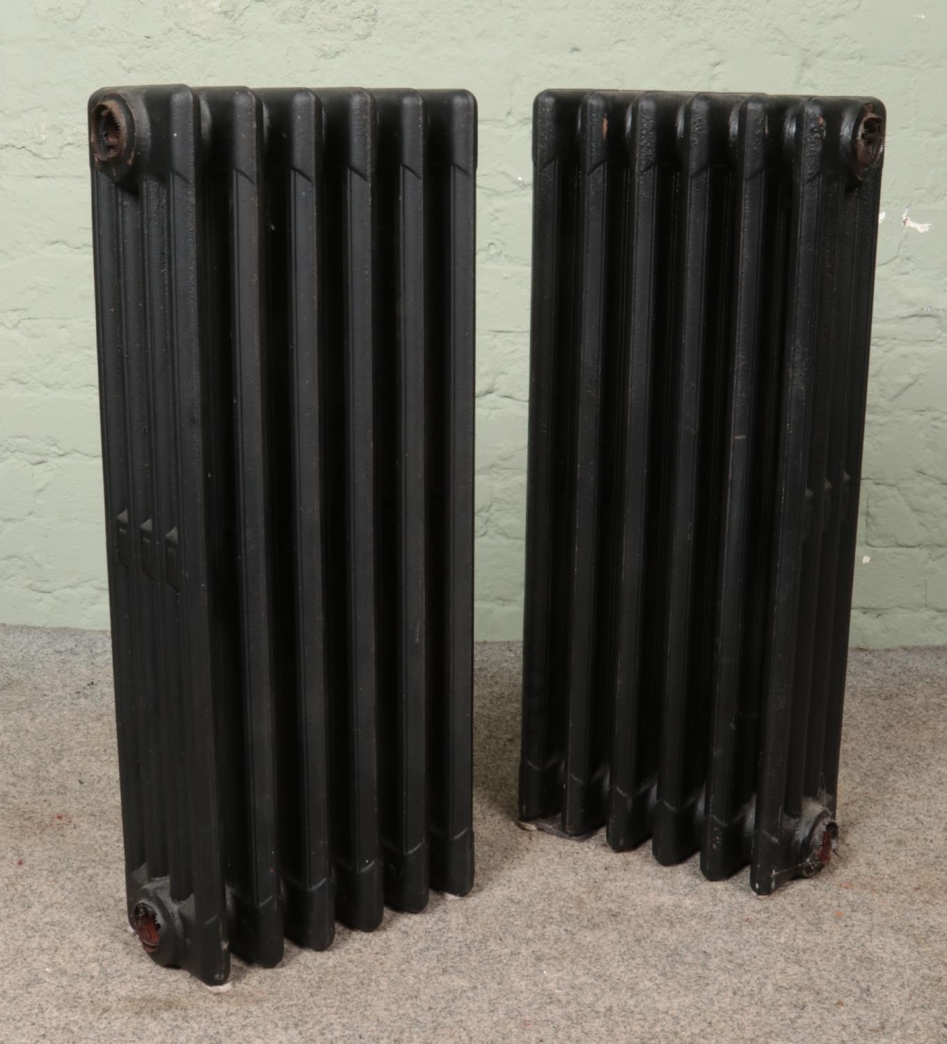 Two painted six-bar cast iron radiators. Height: 75cm.