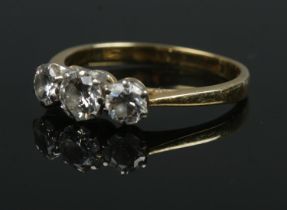 An 18ct gold three stone diamond ring. Approximately 1ct diamond in total. Size P 1/2. 3.17g.