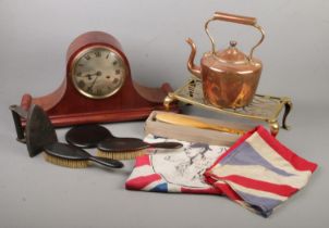 A box of miscellaneous. Includes large mantel clock, copper kettle, brass trivet, vintage Union Jack