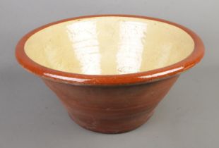A terracotta dairy bowl with glazed interior. 48cm diameter