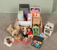 A box of vintage children's toys. Includes Casdon oven and washing machine, Punch Wizard and