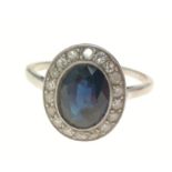 A white metal oval shaped blue stone and diamond ring size M, gross weight 2.60g