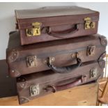 BON VOYAGE!VINTAGE ENSEMBLE of three suitcases, the smaller top suitcase being made of leather