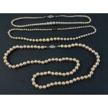 Two strings of LOTUS pearls and a string of faux pearls