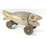 A highly unusual hand-made wooden pull-along fish complete with 2 compartments inside for hiding