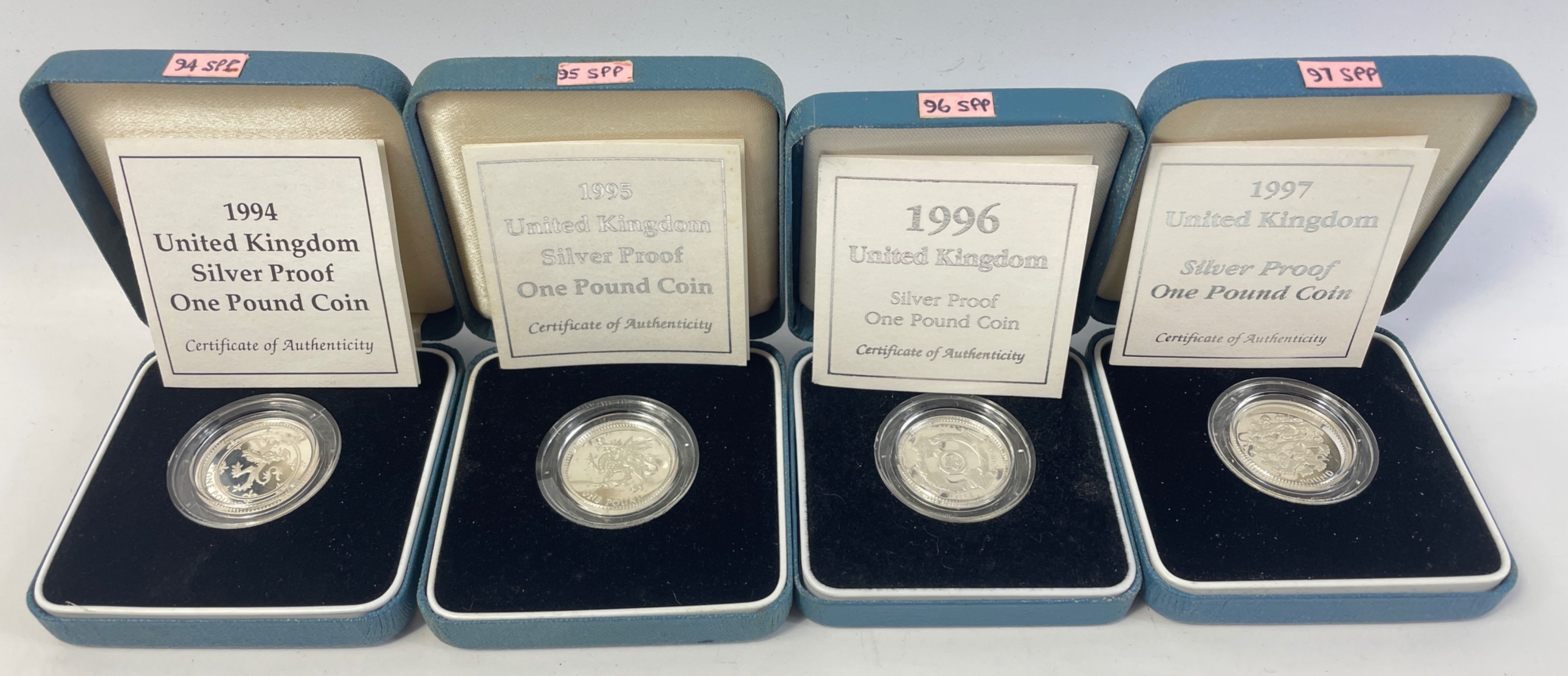 Four boxed ROYAL MINT United Kingdom silver proof one pound coins from 1994, 95, 96, 97