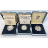 Three boxed ROYAL MINT United Kingdom silver proof one pound coins from 1984, 85 and 86