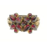STUNNING! An UNMARKED yellow metal floral design red stone set ring Size U, gross weight 3.45g