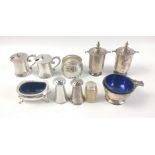 A collection of hallmarked silver cruets to include 2 pepper pots Chester 1913, 2 lidded pots with