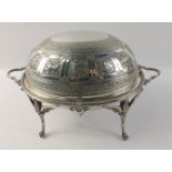 An oval white metal chafing dish with lid decorated with repoussé zodiac symbols standing on 4