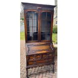 A rather impressive two door glazed BOOKCASE/BUREAU with stretchered base on candy-twist leg