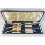 A boxed horn handle three piece carving set in good condition.